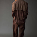 Back view of the Mijeong Park Oversized Plaid Shirt styled with a brown knit over the shoulders