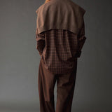 Back view of the Mijeong Park Oversized Plaid Shirt styled with a brown knit over the shoulders