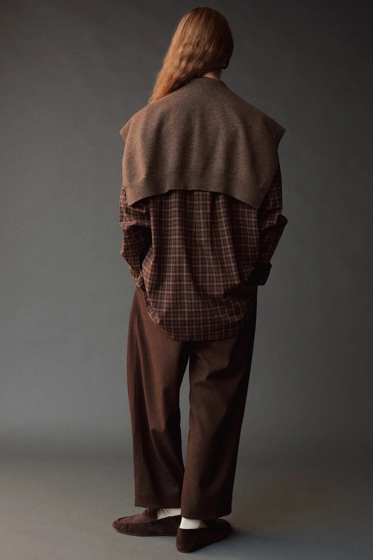 Back view of the Mijeong Park Oversized Plaid Shirt styled with a brown knit over the shoulders