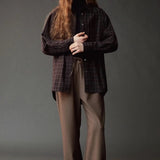 Front view of the Mijeong Park brown plaid shirt layered over a black turtleneck