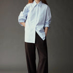 Front view of the Mijeong Park Oversized Shirt in light blue at SHOP YUCCA in Denver