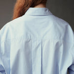 Close back view of the Mijeong Park Oversized Shirt showing the center pleat and dropped shoulders