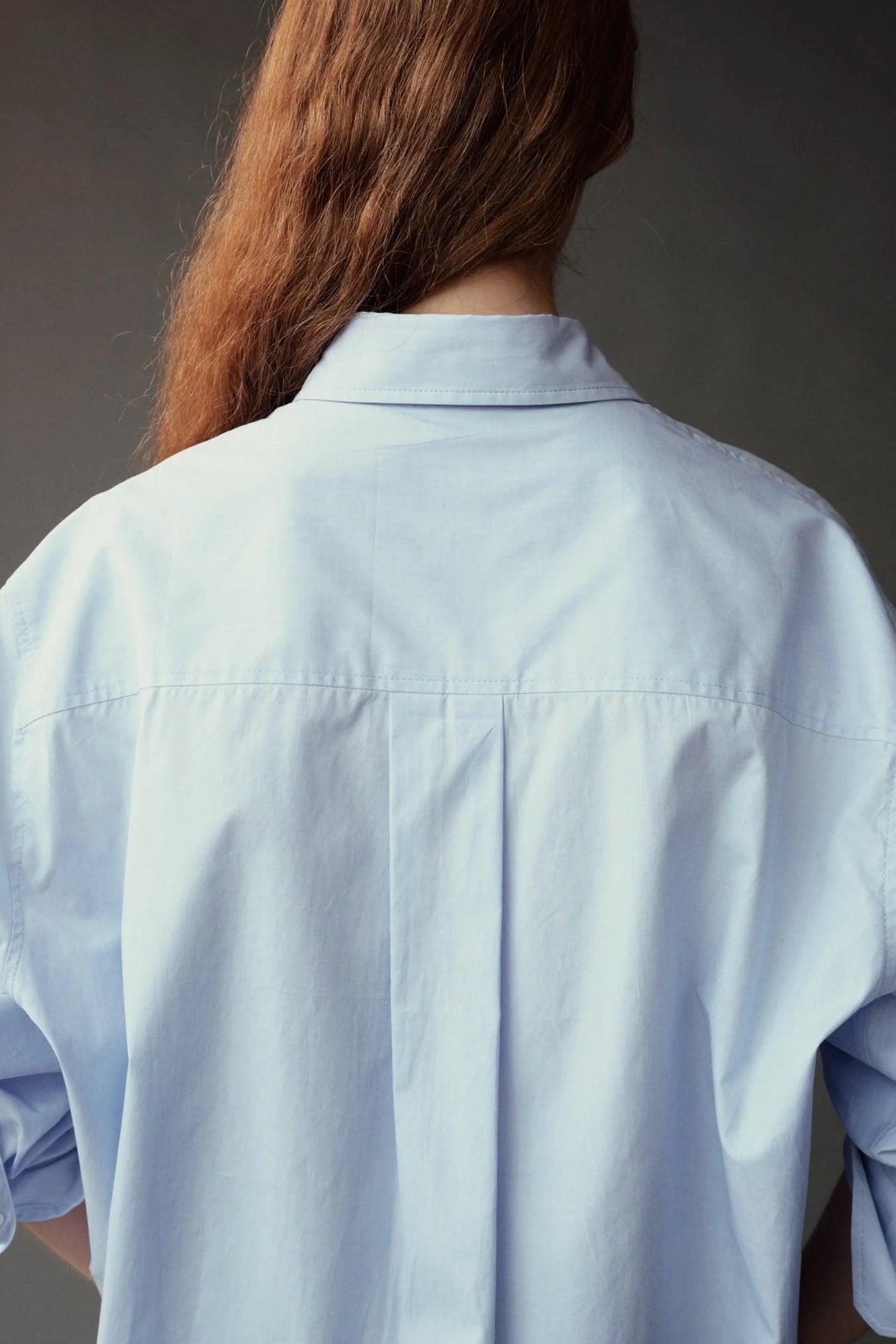 Close back view of the Mijeong Park Oversized Shirt showing the center pleat and dropped shoulders