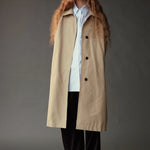 Mijeong Park Oversized Shirt in light blue layered beneath a long beige coat with wide leg trousers