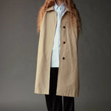 Mijeong Park Oversized Shirt in light blue layered beneath a long beige coat with wide leg trousers