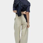 Mijeong Park navy oversized cotton t-shirt back view styled with beige wide leg trousers minimalist relaxed silhouette
