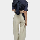 Mijeong Park navy oversized cotton t-shirt back view styled with beige wide leg trousers minimalist relaxed silhouette