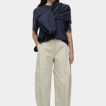 Mijeong Park navy oversized cotton t-shirt styled with beige wide leg trousers minimalist summer outfit
