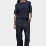 Mijeong Park navy oversized cotton t-shirt full outfit view relaxed minimalist tee styled with dark denim pants