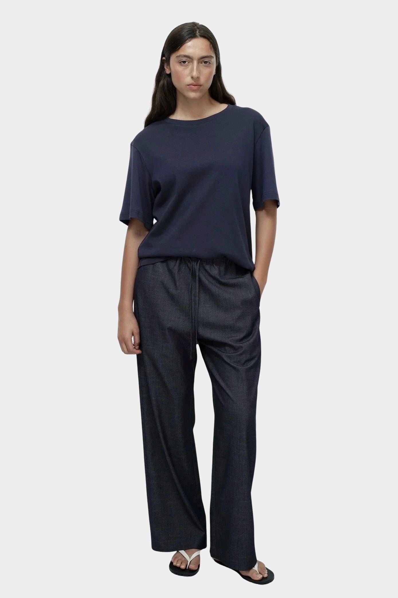 Mijeong Park navy oversized cotton t-shirt full outfit view relaxed minimalist tee styled with dark denim pants