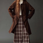Mijeong Park brown plaid midi skirt styled with an oversized brown coat and ivory turtleneck