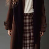 Close detail of the Mijeong Park Plaid Midi Skirt styled with a brown coat and dark scarf