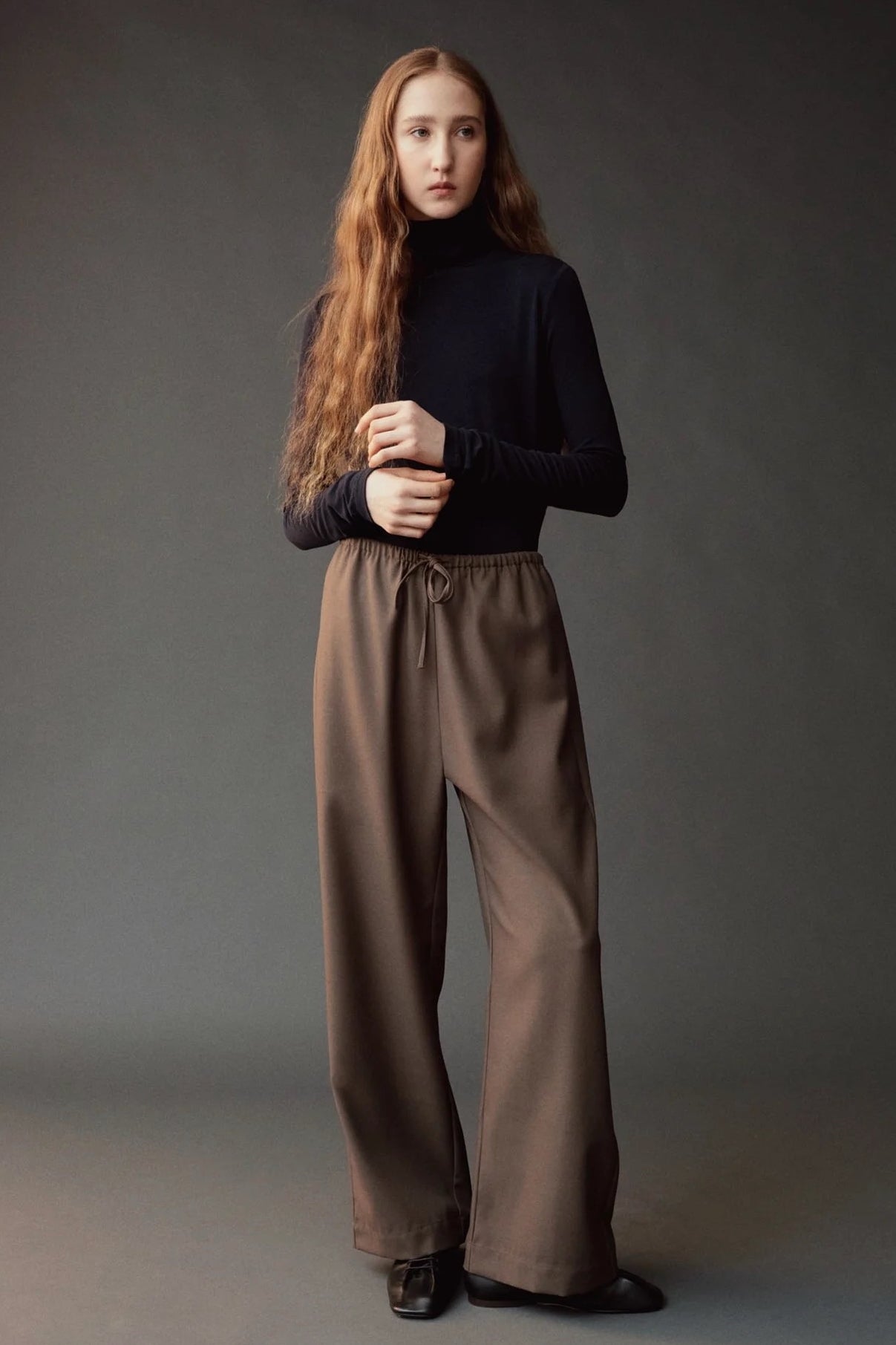 Front view of the dark navy roll neck jersey top at SHOP YUCCA in Denver.