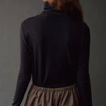 Close back view of the dark navy roll neck jersey top with slim long sleeves.