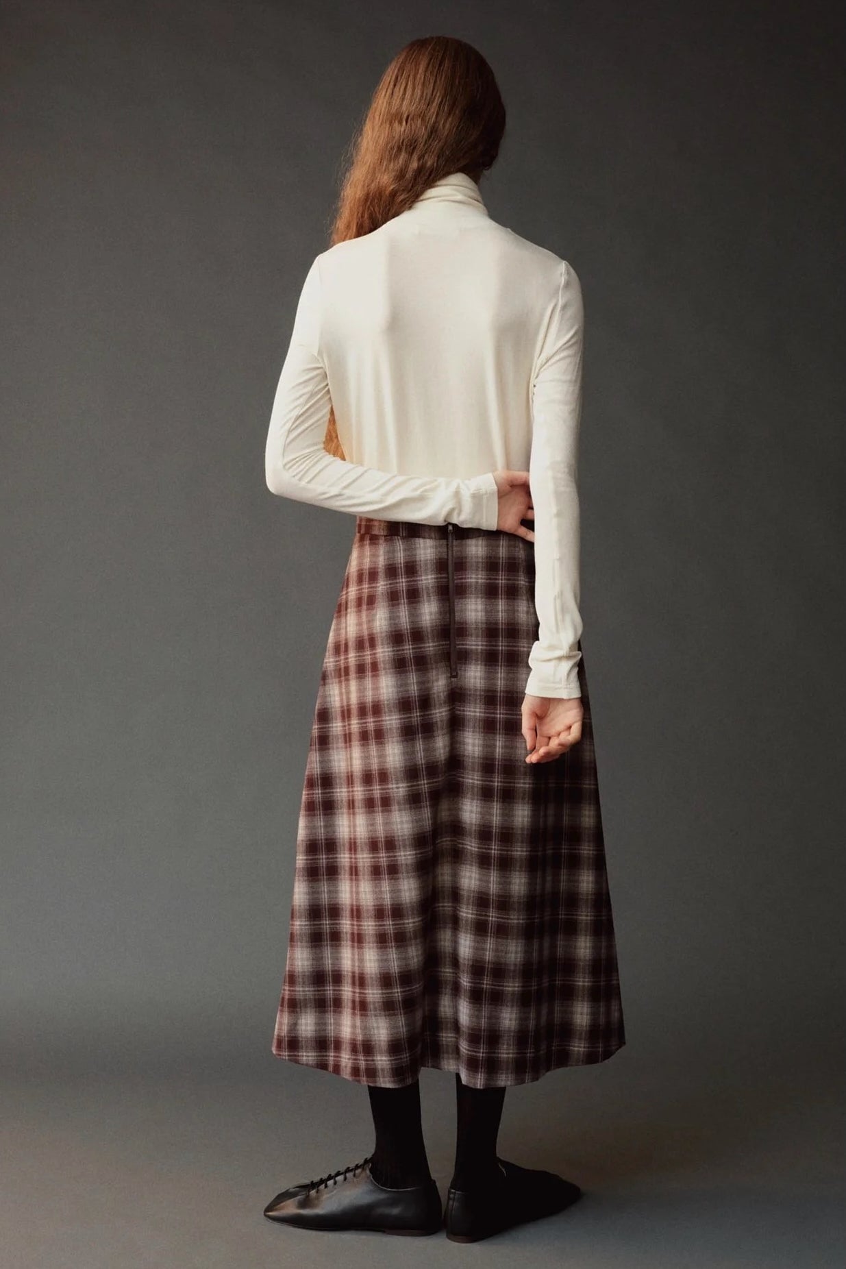 Back view of the ivory roll neck jersey top with long sleeves and a slim fit.