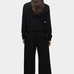 Back view of semi sheer linen blend knit top in black by Mijeong Park with relaxed lightweight fit