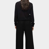 Back view of semi sheer linen blend knit top in black by Mijeong Park with relaxed lightweight fit