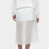 Back view of semi sheer linen blend knit top in white by Mijeong Park paired with sheer midi skirt