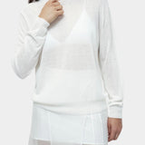 Detail of semi sheer white linen blend knit top by Mijeong Park with crew neckline and relaxed lightweight knit