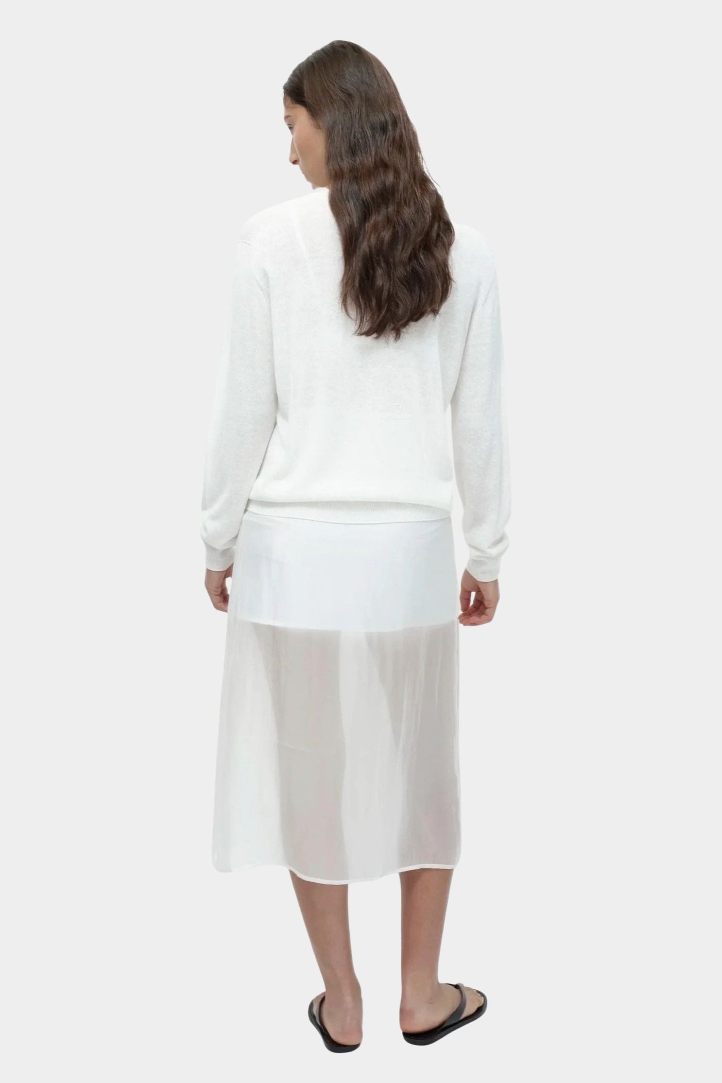 Back view of semi sheer linen blend knit top in white by Mijeong Park, lightweight long sleeve crewneck sweater