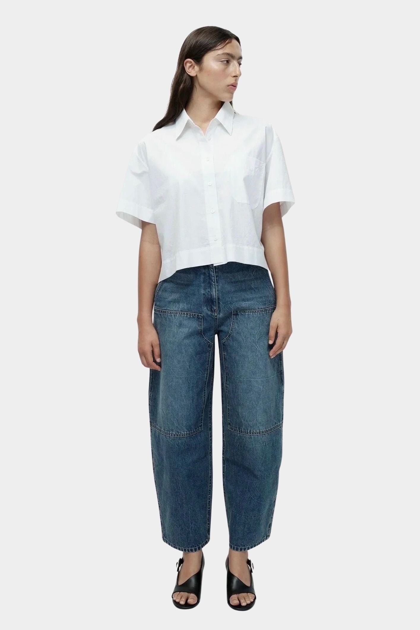 White cropped cotton poplin short sleeve shirt styled with relaxed straight leg denim