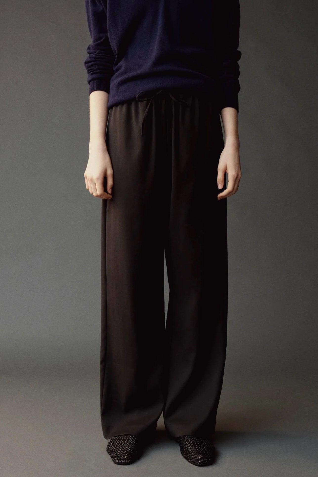 Close front view of the Mijeong Park Wool Blend Drawstring Pants showing the elastic waist and tie