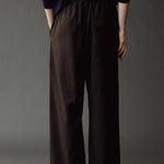 Close back view of the Mijeong Park black pants showing the elastic waist and rear welt pocket