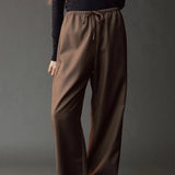 Close front view of the Mijeong Park olive brown pants showing the drawstring waist and fluid drape