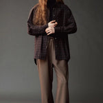 Front view of the Mijeong Park Wool Blend Drawstring Pants styled with a dark plaid shirt