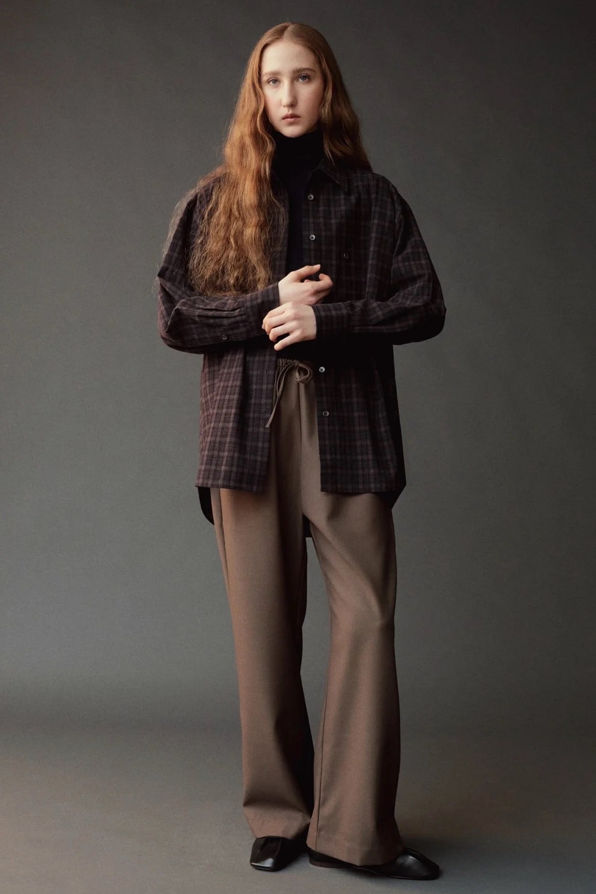 Front view of the Mijeong Park Wool Blend Drawstring Pants styled with a dark plaid shirt