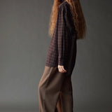 Side view of the Mijeong Park olive brown drawstring pants showing the relaxed wide leg