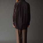 Back view of the Mijeong Park Wool Blend Drawstring Pants in olive brown styled with a plaid shirt