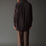 Back view of the Mijeong Park Wool Blend Drawstring Pants in olive brown styled with a plaid shirt