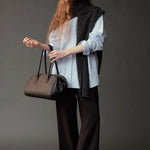 Mijeong Park Wool Blend Knit Shawl Charcoal draped over blue shirt with black trousers