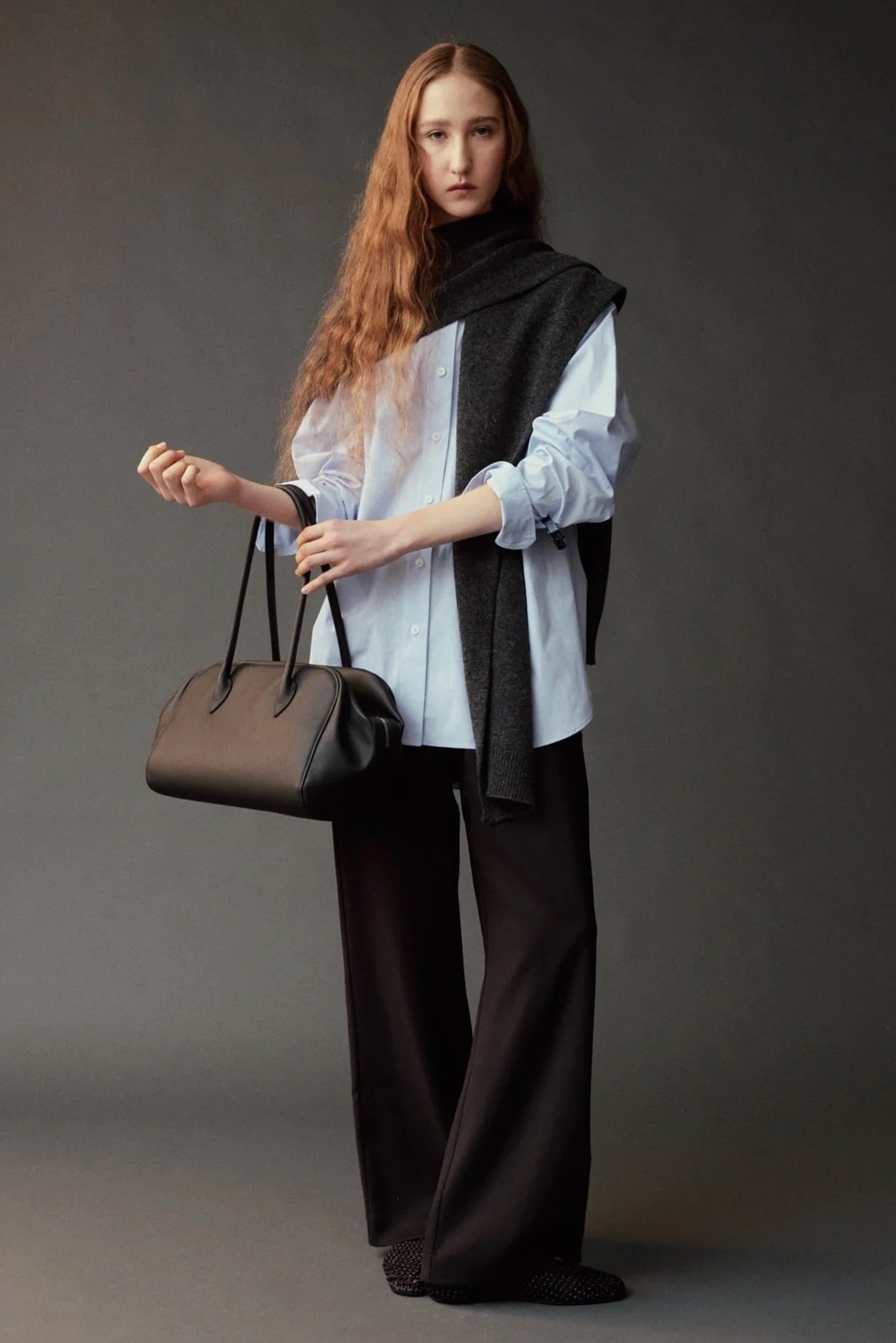 Mijeong Park Wool Blend Knit Shawl Charcoal draped over blue shirt with black trousers