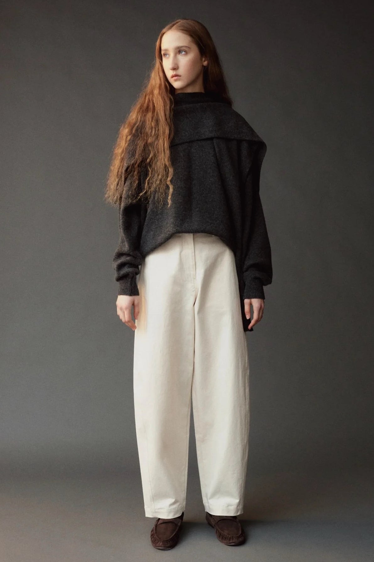 Mijeong Park Wool Blend Knit Shawl Charcoal layered over dark sweater and ivory trousers