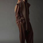 Mijeong Park Wool Blend Knit Shawl Light Brown draped over plaid shirt and brown trousers