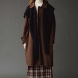Mijeong Park Wool Blend Knit Shawl Navy layered over brown coat and plaid skirt at YUCCA Denver