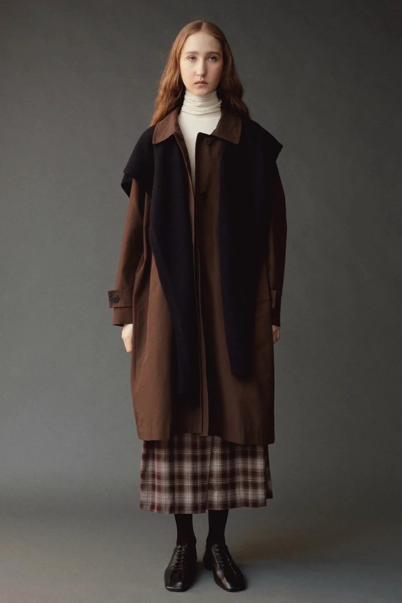 Mijeong Park Wool Blend Knit Shawl Navy layered over brown coat and plaid skirt at YUCCA Denver