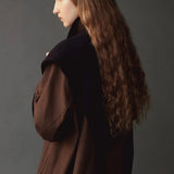 Mijeong Park Wool Blend Knit Shawl Navy worn over shoulders with brown coat, side view