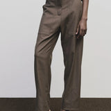 Light brown wool blend workwear trousers by Mijeong Park
