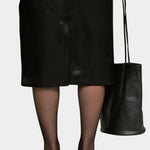 Black Drape Oval Bucket carried by hand with a black skirt and sheer tights