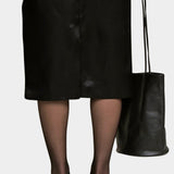 Black Drape Oval Bucket carried by hand with a black skirt and sheer tights