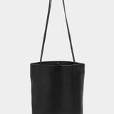Front view of the Modern Weaving Drape Oval Bucket in black with long shoulder straps
