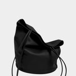 Soft black leather Drape Oval Bucket resting on its oval base with the top draped inward