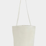 Front view of the Modern Weaving Drape Oval Bucket in Creme with long shoulder straps