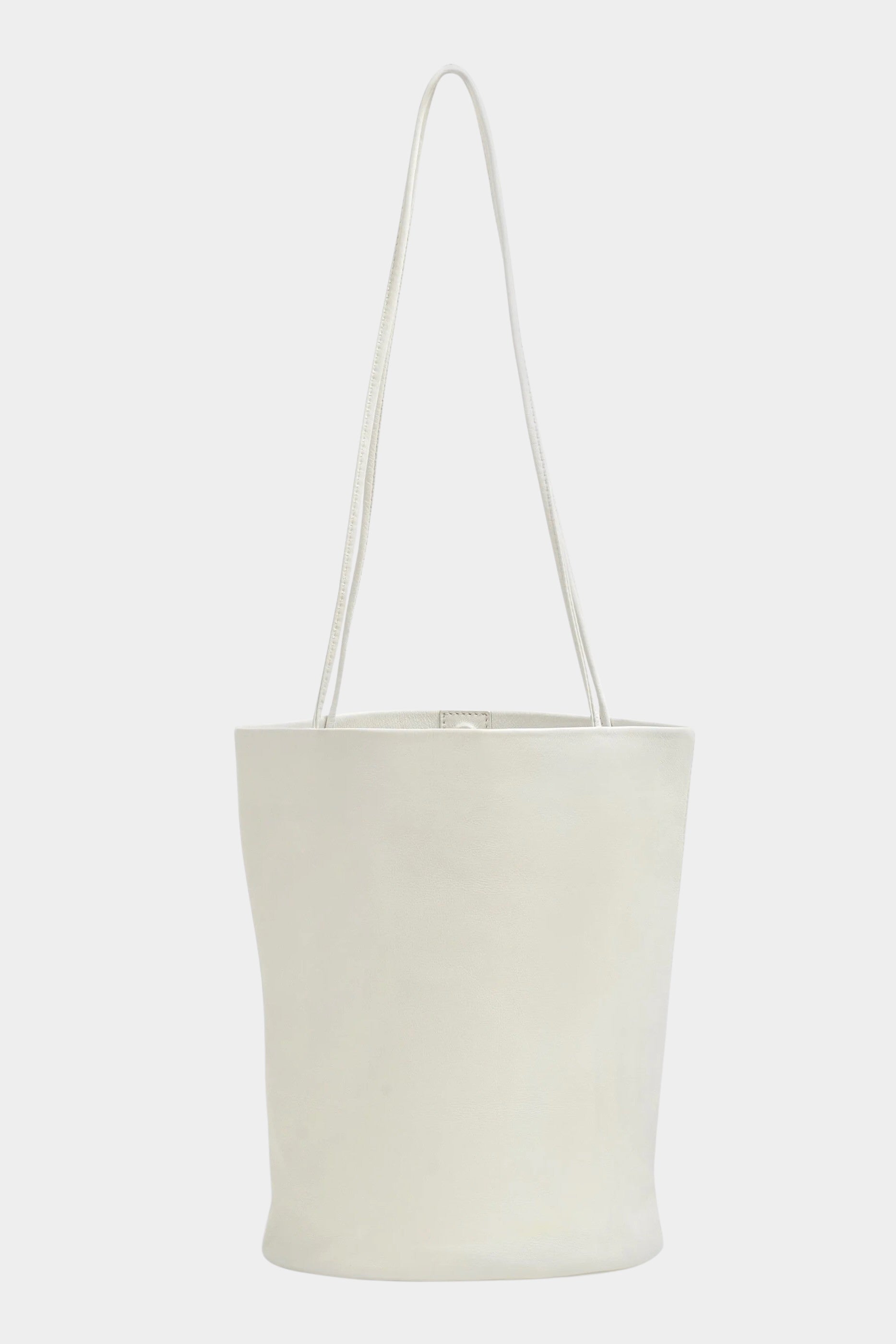 Front view of the Modern Weaving Drape Oval Bucket in Creme with long shoulder straps