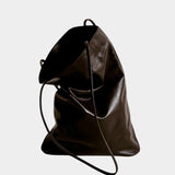 Modern Weaving Slim Elongated Tote in Braun leather with a softly folded shape and slender straps, at YUCCA Denver.