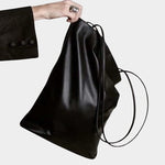 Modern Weaving Slim Elongated Tote Black in Italian lamb leather with soft structure and long shoulder straps