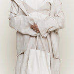 Modern Weaving Slim Elongated Tote Creme styled with neutral outfit showing soft leather drape and elongated shape